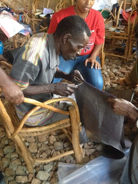 Men and women in Mitaboni, Kenya, participate in a co-design session focused on water transport and storage technology.