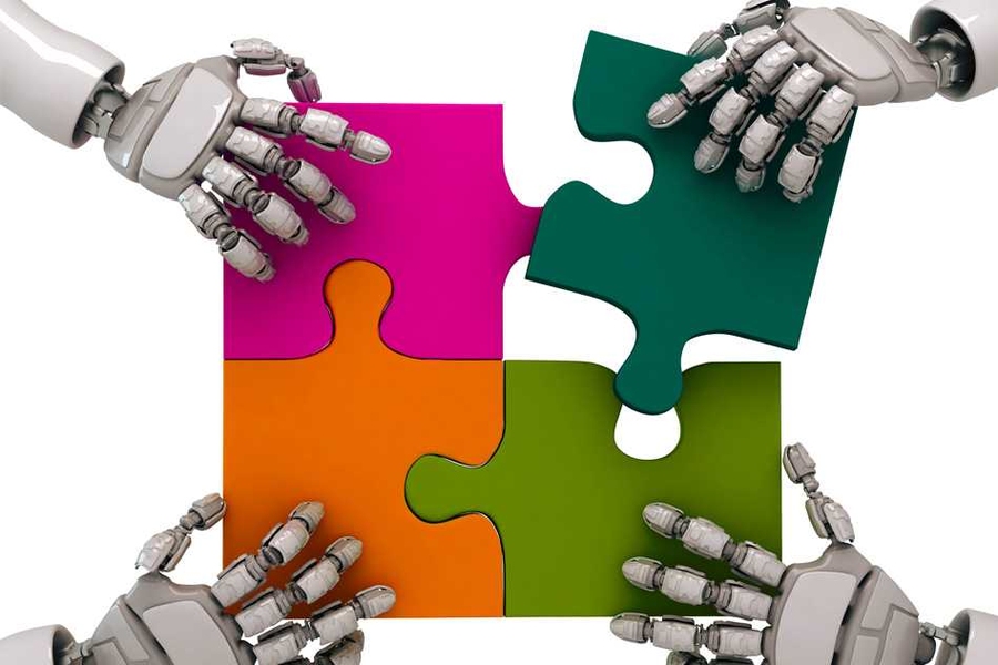 Four puzzle pieces in the center of the image are each being grabbed by a robotic hand reaching in from each corner of the image