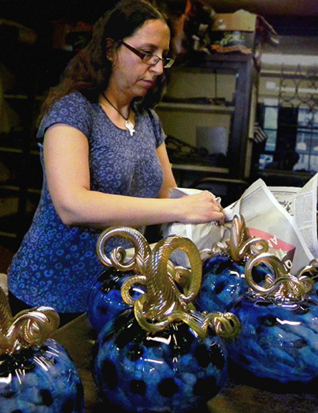 MIT Glass Lab Technical Instructor Michelle Trammel wraps glass pumpkins.
