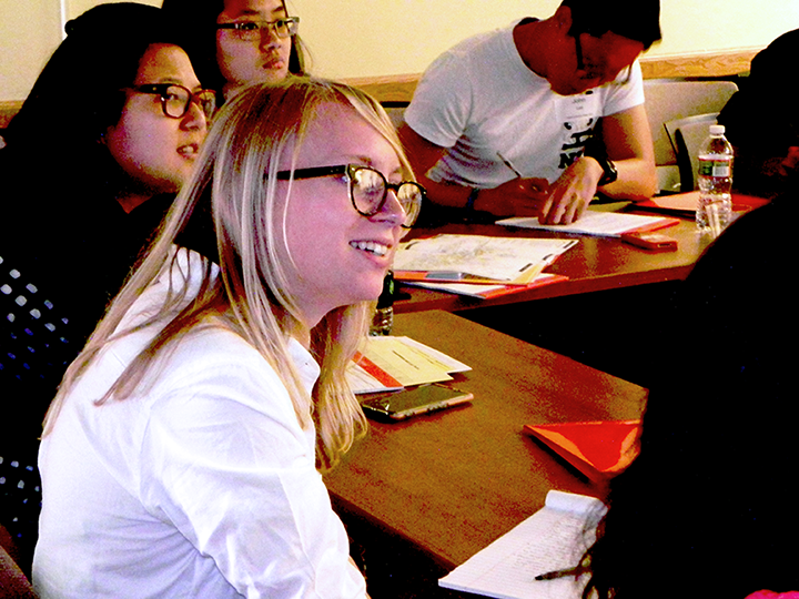 Catherine Groschner, who will intern this summer in professor of chemical engineering Fikile Brushett's lab, listens to a presentation about his project to create fuel from carbon dioxide.