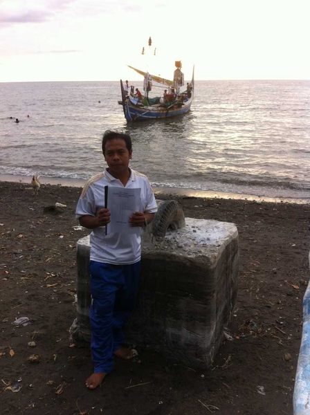 A reef cooperative member in Lovina, Indonesia, holding his organization’s rules charter.