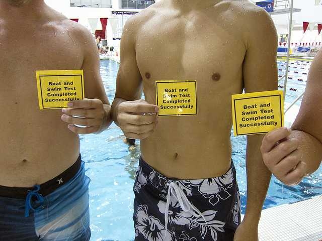 MIT students hold evidence of swim-test success.