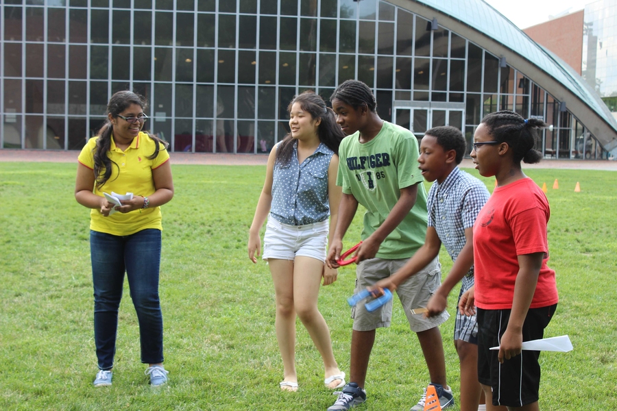 As part of the Math Olympics for their level-three probability and statistics course, Kathryn Miranda, Shirley Cheung, Calvin Hill, Dennis Mullings, and Angelique Jean-Noel (left to right) toss horseshoes before completing math problems.