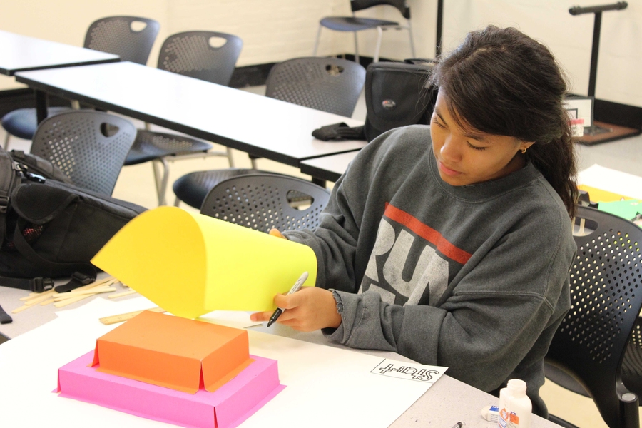 Level-four student Erika Pun builds a precalculus-based board game in preparation for the 2014 STEM Summer Institute Final Ceremony.