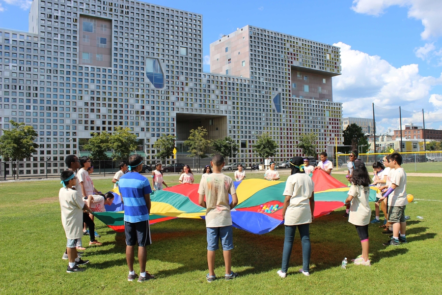 Students of all levels come together to play parachute games outside of Simmons Hall as part of field day on the last day of the 2014 STEM Program.