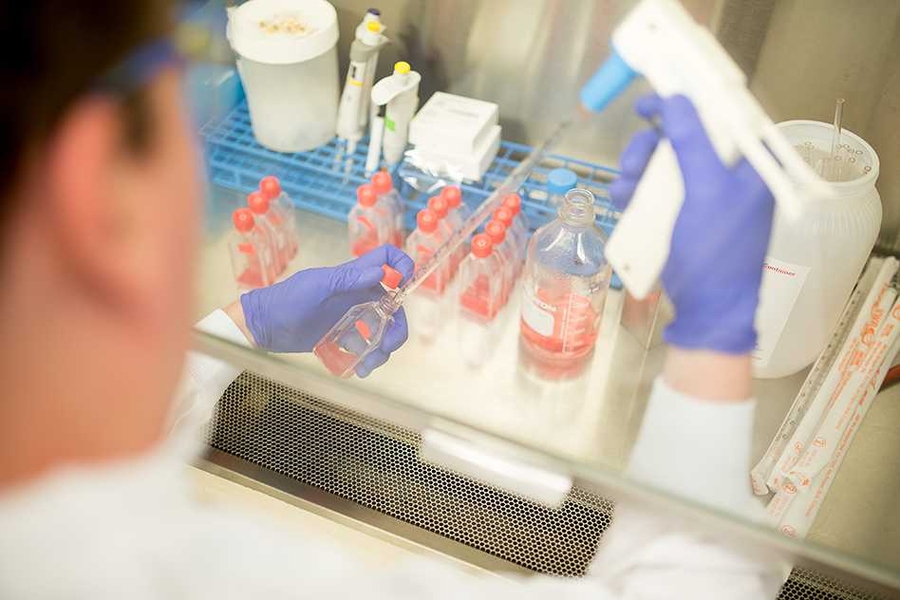 Jeffrey Wagner dispenses liquid in beaker with device