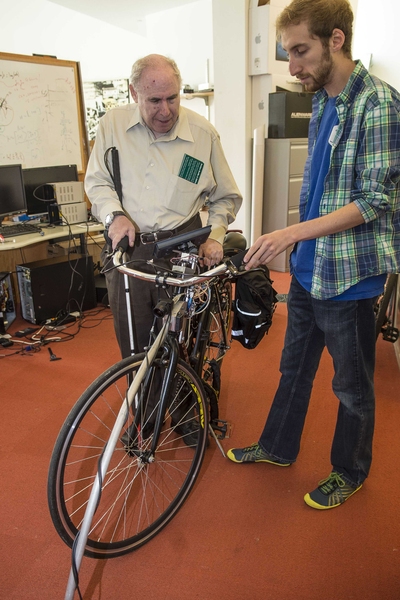 Jeffrey Drucker, left, discusses the blicycle with Steve Levine, who developed the device as a 6.811 (Principles and Practices in Assistive Technologies) student in the inaugural offering of the class by Seth Teller in 2011.