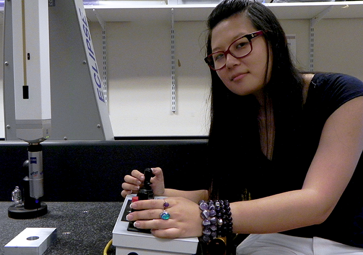 Jessica Ma uses a coordinate measurement machine to map the surface of a sample block at 3,000 different points to provide a baseline for comparison in corrosion studies of nuclear fuel canisters. Ma studied stress analysis of the nuclear canisters to create a model based on real sample surfaces for calculating residual stress on the surface.