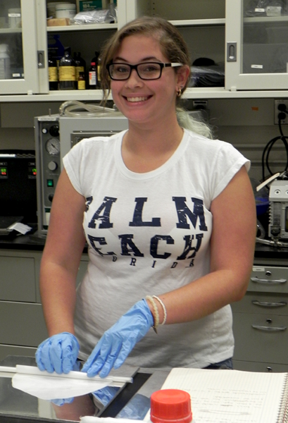 Karen Diaz Toledo works with rolls of polycaprolactone polymer that will be drawn into hollow fibers. She makes the thin layers from pellets, then winds several layers around a hollow rod to a diameter of about 30 millimeters. The drawn hollow fibers could possibly be used for drug delivery or cell transport.