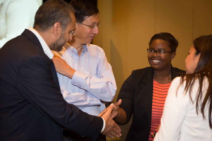 SanDisk Senior Vice President Gursharan Singh shakes hands with MIT freshman Kayla Tabb, a 2013 alumna of E2@MIT. SanDisk leaders traveled to the event from across the globe; Singh’s manufacturing and supply-chain operations role is based in India.