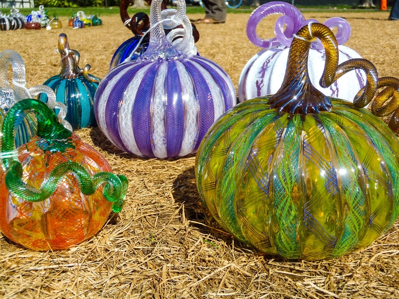 Glass pumpkins sit on the grass in front of MIT's Student Center