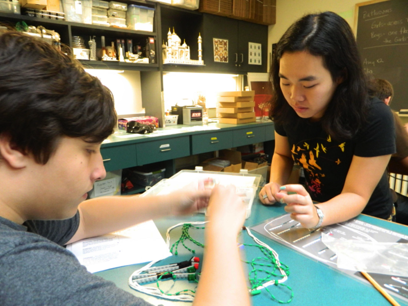 Jenny Zheng ’14, one of Fitzgerald’s staff members, assists a student building a model of a cell in the process of cell division in the Shape of Life class. In this class, students use LEGO bricks to model the basic structural elements of DNA, bringing the form and function of the double helix alive.