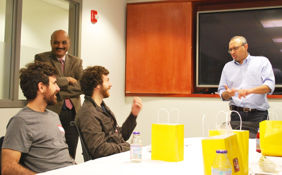 Bhaskar Pant looks on as ASP students Nicanor Bailez and Denes Csala talk with Sanjay Sarma (right).