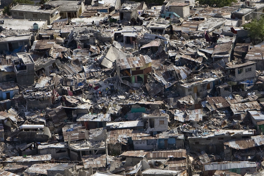 Displacement can result from a number of factors including natural disasters, armed conflicts, medium- and large-scale development projects, resource extraction, and even neighborhood gentrification. Pictured here: earthquake damage in Haiti.
