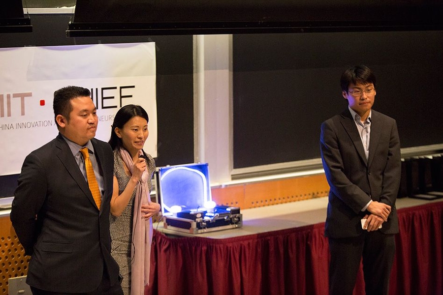 BelLEDs Technologies team members (left to right) Patrick Lin, Xiaolu Li, and Michael Chen deliver their pitch, complete with a working prototype of their smart LEDs (center, in the suitcase) that illuminated to the sound of music.