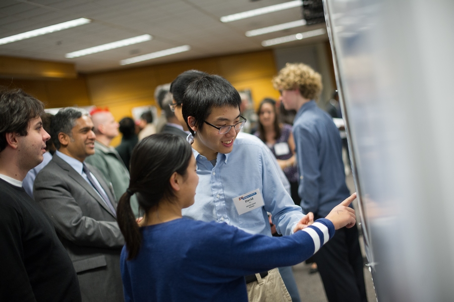 SuperUROP, faculty advisers, and industry sponsors packed the MIT Grier Room. Anantha Chandrakasan (second from left), EECS department head and creator of the program, visited with each of the students.