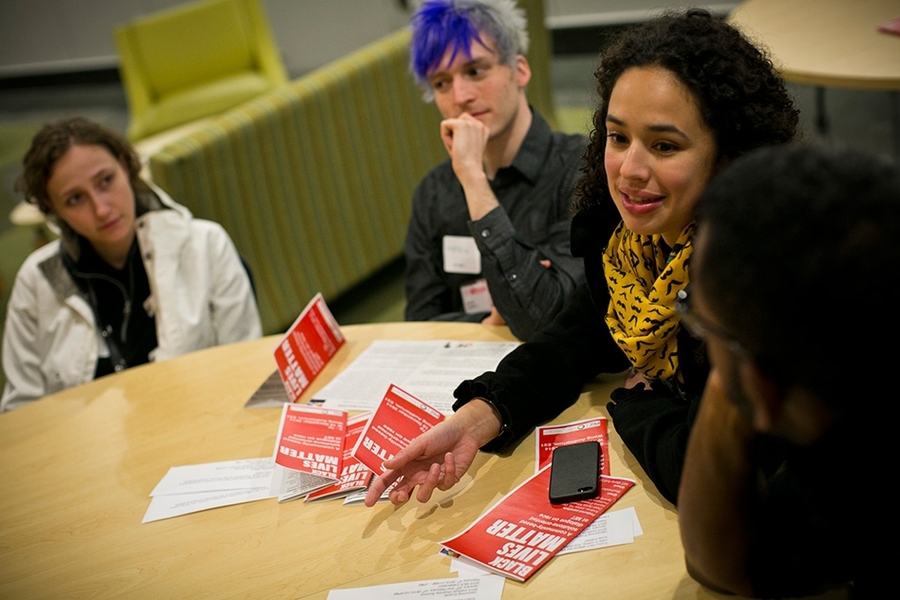 Four students surround round table with Black Lives Matters pamplets.