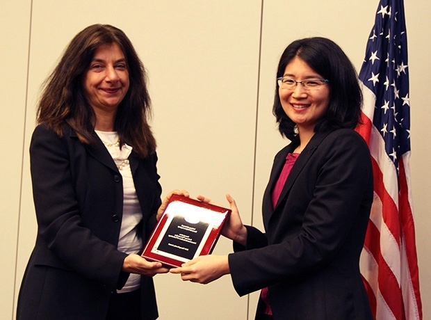 Vivienne Sze (right) receives the DARPA Young Faculty Award (YFA) from Fariba Farhoo, the DARPA YFA program manager, on Oct. 3 in Arlington, Va.