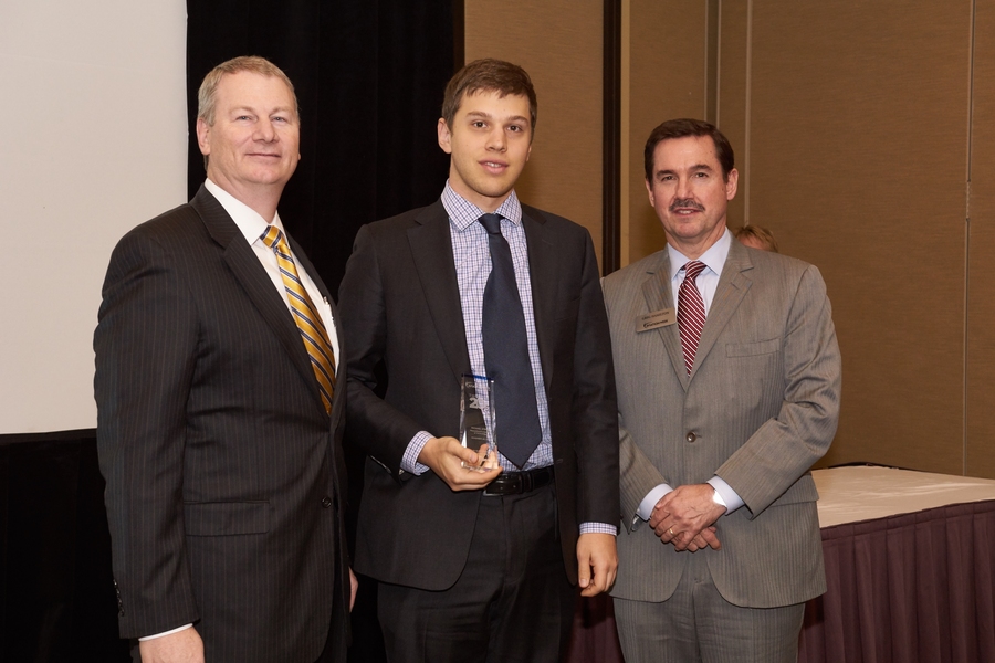 Michael Stern (center) accepted a trophy recognizing his selection as one of <i>Aviation Week's</i> "Tomorrow’s Engineering Leaders." Presenting the award at the Aerospace and Defense Programs Conference in November are Wes Kremer (left), vice president for air and missile defense systems at Raytheon Missile Systems, and Greg Hamilton, president of <i>Aviation Week.</i>