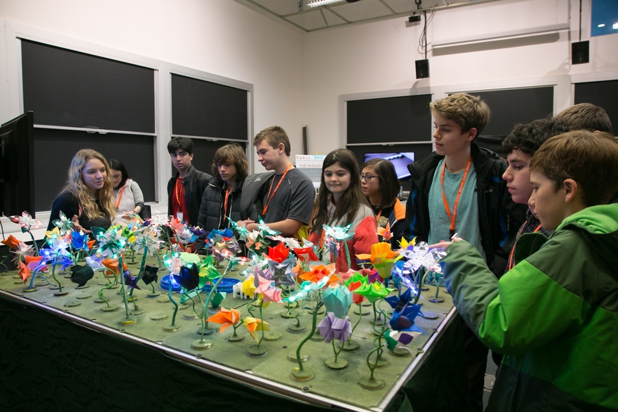 CSAIL researcher Lindsay Sanneman (left) shows students the "robot garden."