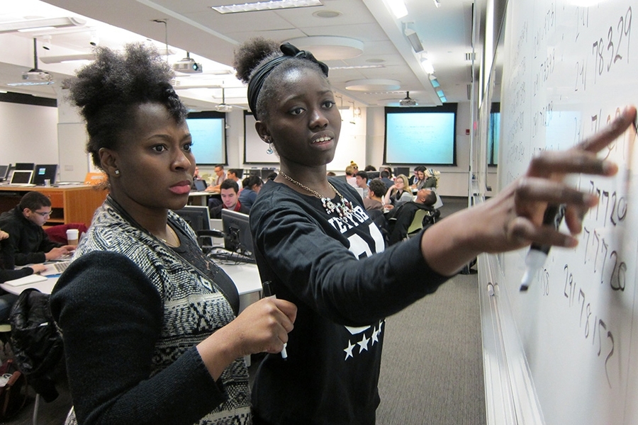 Ruka Aderogba (left), a psychology major at Hunter College, and Favour Akinjiyan, a biology major at the New York Institute of Technology, work together on a Python coding exercise.