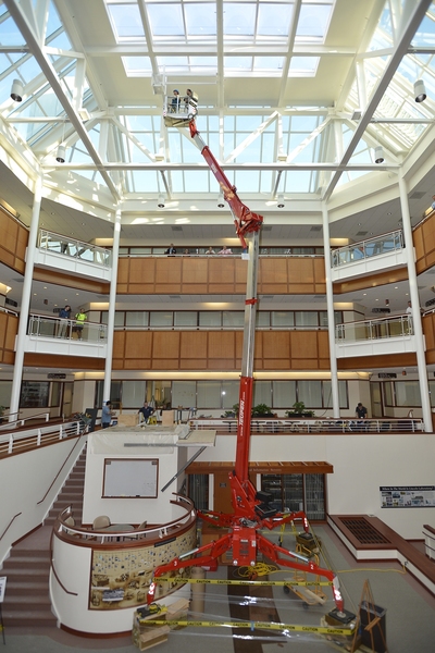 The pendulum is hung in the atrium outside Lincoln Laboratory's library. The height of the skylight ceiling drove the decision to power the pendulum from beneath the base installed at a second-floor landing.