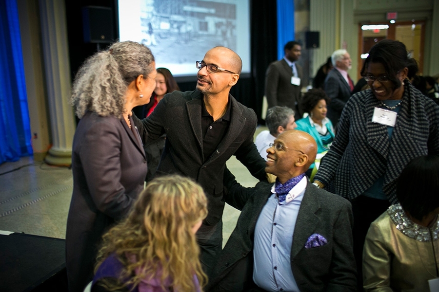 MIT professor of writing Junot Diaz converses with professor of fiction writing Helen Elaine Lee (left), professor of linguistics Michel DeGraff (seated), and others at the annual Dr. Martin Luther King Jr. luncheon.