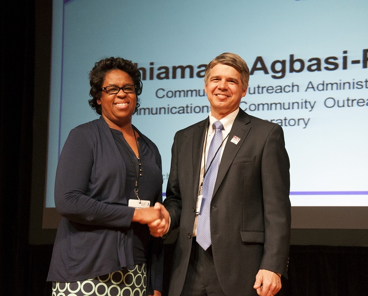 Eric Evans presents an Unsung Hero Award to Chiamaka Agbasi-Porter.