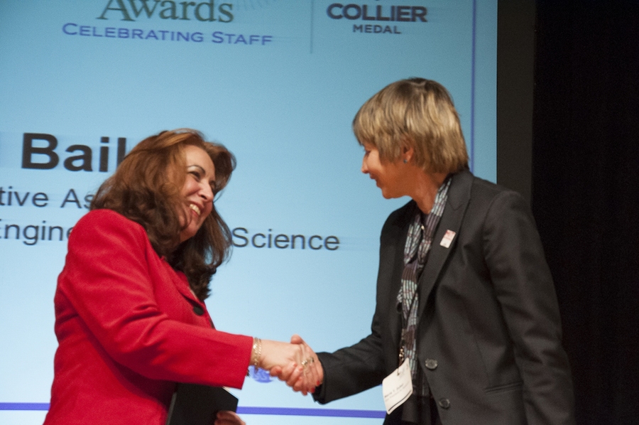 Maria Zuber (right) presents an Unsung Hero Award to Carol Bailey.