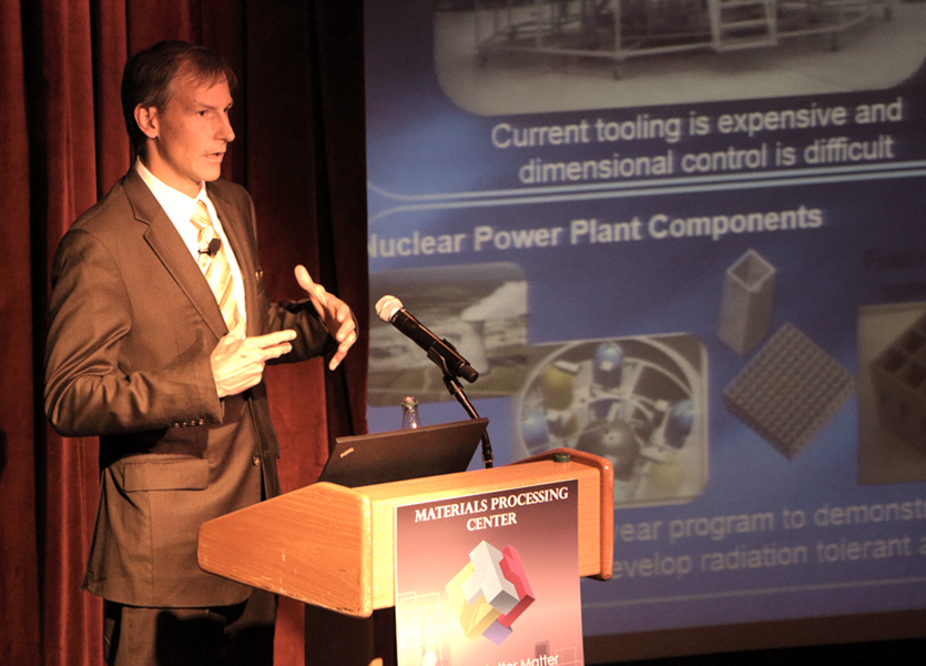 Lockheed Martin Fellow Slade Gardner describes improvements in production, design, and cost in making parts for air and spacecraft during the Materials Day Symposium on Oct. 21, 2014, at MIT.