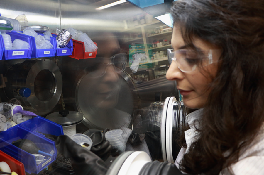  MIT electrical engineering graduate student Farnaz Niroui works in a glovebox, where she prepares a sample for deposition of gold. The glovebox is attached through a transfer line to a thermal evaporator that deposits the gold coating onto squeezable switches, or “squitches,” which Niroui designs, fabricates, and tests in the Organic and Nanostructured Electronics Lab at MIT.