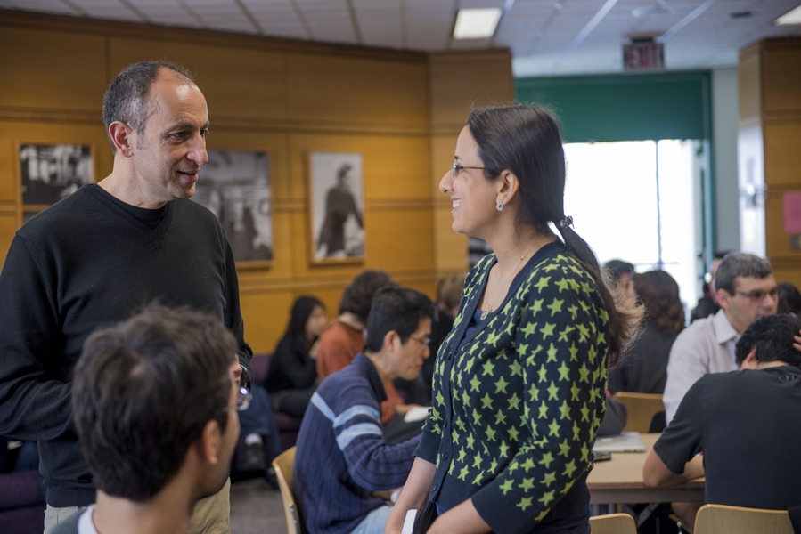 Munther Dahleh (left), director of MIT's Engineering Systems Division, speaks with postdoctoral associate Rose Faghih at a Postdoc6 workshop.