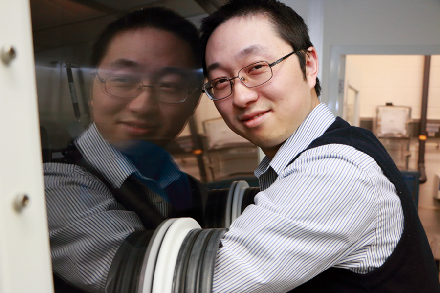 Hu stands at a glove box used to make solutions of glass materials and then deposit them in thin-film form. His lab makes make flexible photonic devices by depositing chalcogenide glass materials onto polymer substrates. "This is our workhorse to make the glass thin films," he says.
