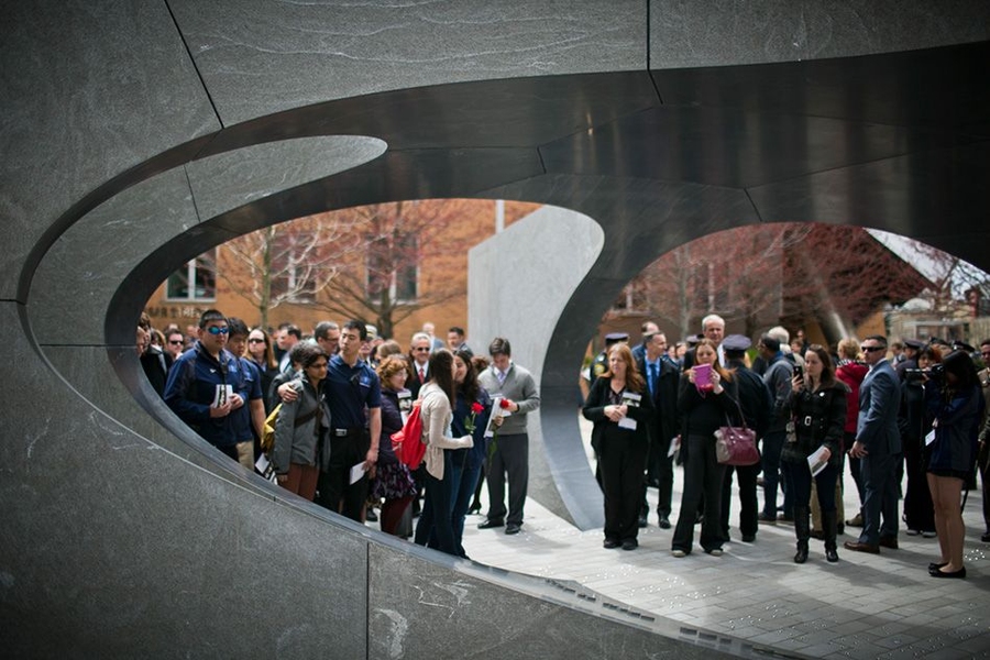 The smooth, curved vault of the granite memorial is supported by five radial walls. Members of the MIT community gathered around and inside the structure following today's ceremony.