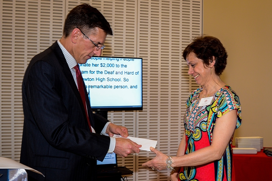 Brian Ducharme, president and CEO of the MIT Federal Credit Union, presents Barbara Johnson with the People Helping People Award at the credit union's 75th anniversary reception on April 21.