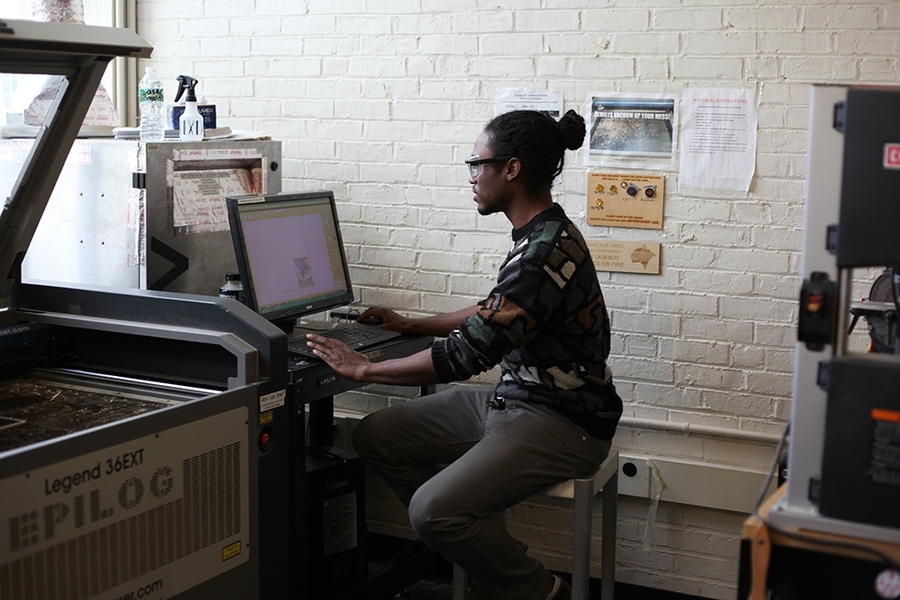 Daniel prepares his design for the laser-cutter.