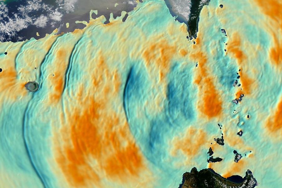 Satellite image of the South China Sea with colors added to indicate the calculated vertical displacement of ocean layers near 200 meters deep, based on simulated model data and calculations run by Harper Simmons at the University of Alaska at Fairbanks and depicted by a graphics team at the University of Washington. Orange indicates upward movement, and blue indicates downward movement.