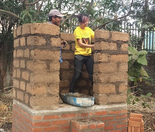 Elaine Kung '15 at work on the construction of a newly designed compost toilet in Santa Ana, El Salvador.