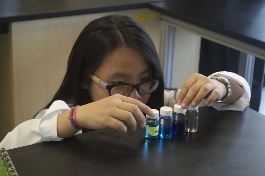 Ruby Fu examines liquid specimens. 