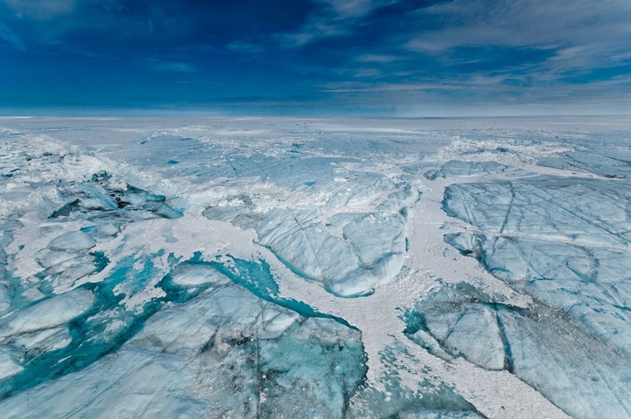 A water-filled hydro-fracture and ice blocks remain after a supraglacial lake drained on Greenland's ice sheet in 2011.