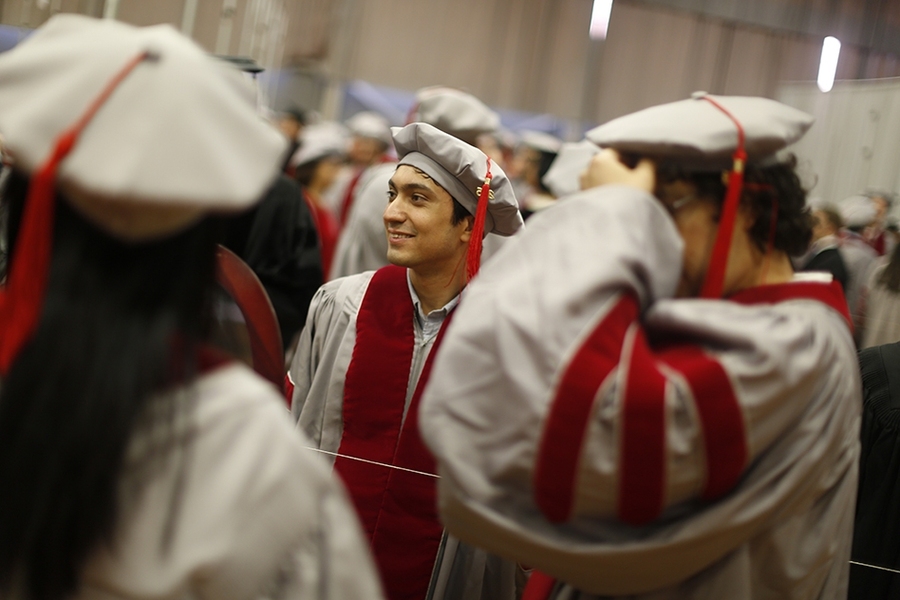 Students suit up and mingle before the hooding ceremony.