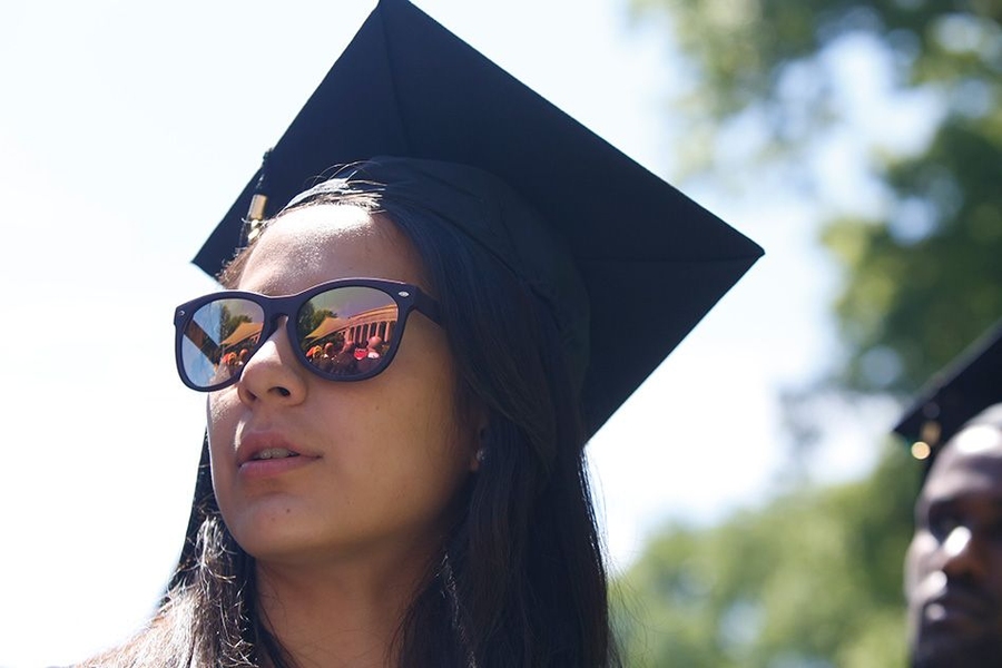 A female student looks out with sunglasses during MIT Commencement