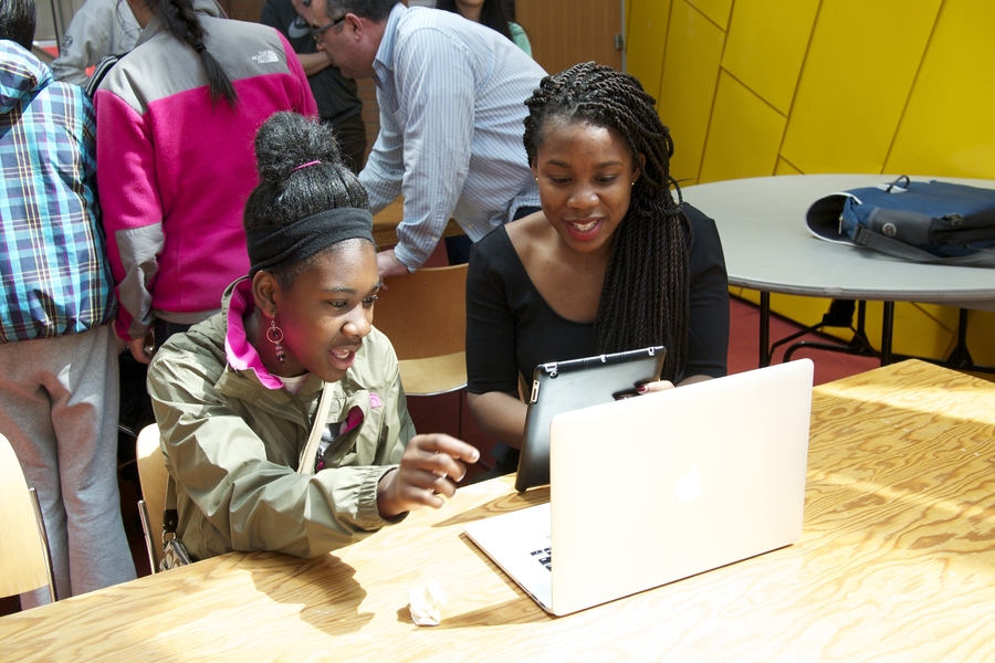 Seventh-grade student Doralee Heurtelou of Cambridge, Massachusetts, remotely controls a robot in a California hospital with her mentor and recent Yale University graduate Kristia Wantchekon.