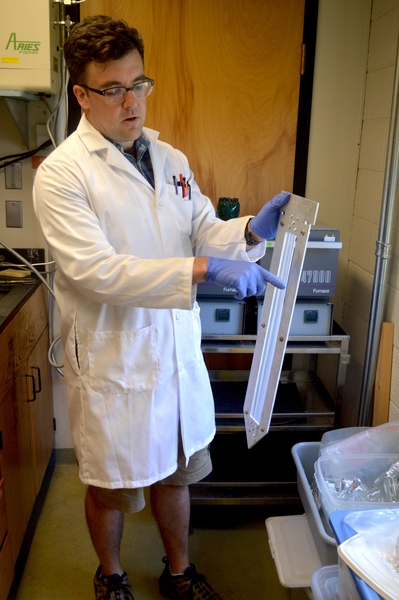Dan Prendergast prepares a passive sampler for analysis after deployment in Duwamish River sediment.