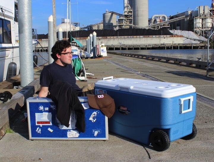 Dan Prendergast rests with instruments and a cooler of samplers.