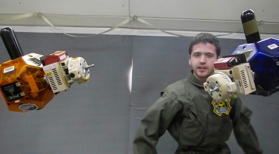 MIT Space Systems Laboratory graduate student Duncan Miller carries out tests of SPHERES satellites with the Universal Docking Port on a flight aboard NASA’s reduced gravity aircraft in 2014.