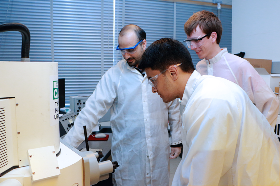 Scanning electron microscope: Postdoc Amir Tavakkoli Kermani Ghariehali (left) shows the scanning electron microscope in Professor Karl Berggren’s lab to CMSE-MPC Summer Scholars Jonah Sengupta (center) and Bartholomeus Machielse. Sengupta will work in the lab this summer as a National Science Foundation research experience for undergraduates intern.