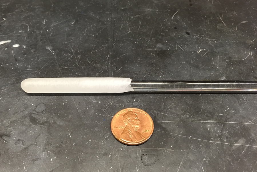 A glass rod is used to form the wax capsules that can store chemical compounds.