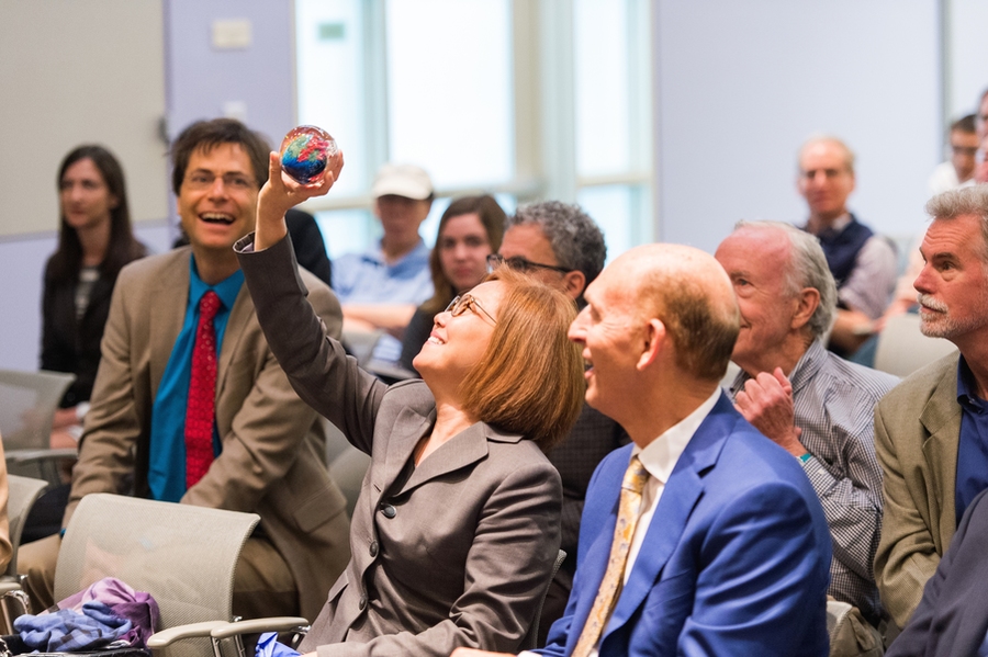 MIT Vice President for Research Maria Zuber presented Robert Conn, president of The Kavli Foundation, and Miyoung Chun, their executive vice president for science programs, with "megaplanets” designed by glass artist Josh Simpson. Chun displays her gift for the audience.