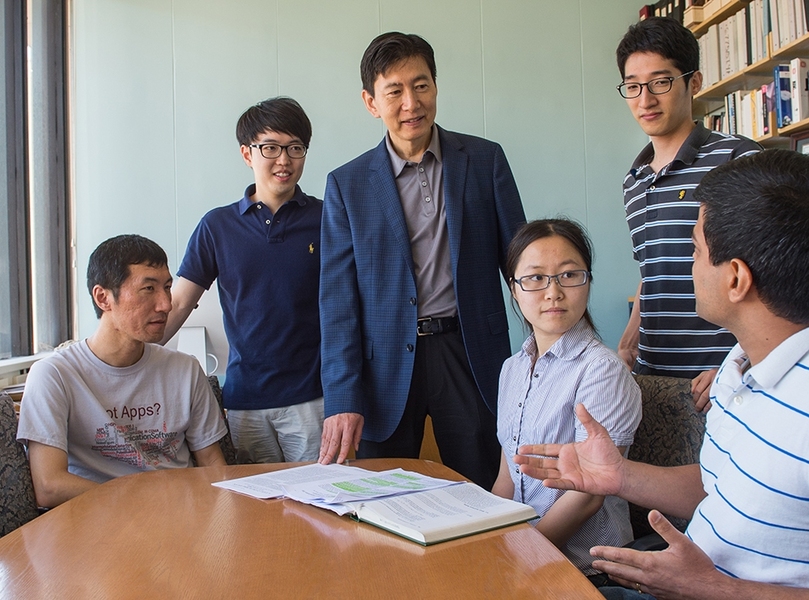 Professor Hae-Seung Lee (in blue blazer) advising graduate students
